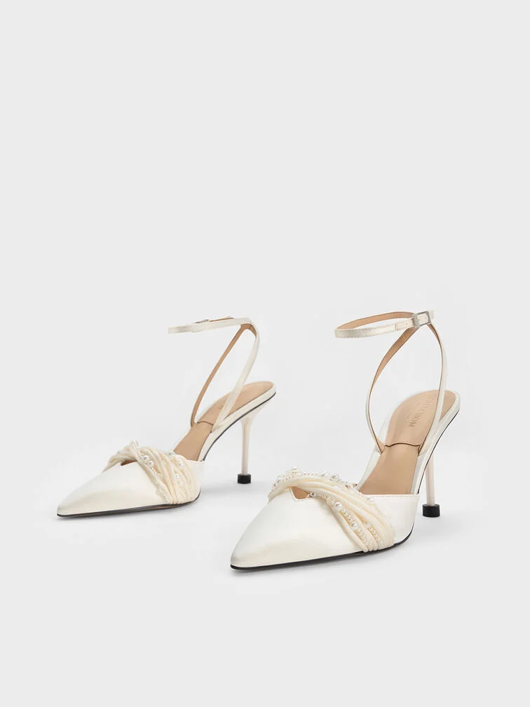 White satin ankle-strap pumps with beaded details, made for the modern bride.
