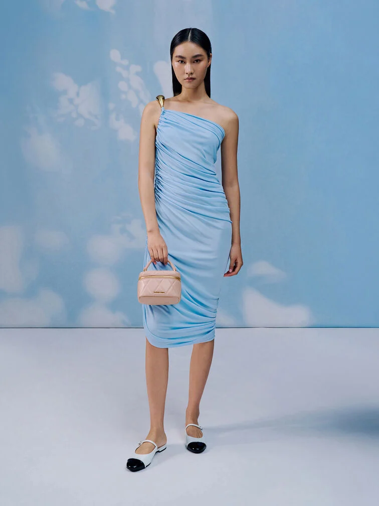 A light blue one-shoulder dress — paired with a pink top-handle bag and toe-cap slip-ons — makes a relaxed yet elegant garden party wedding outfit.  