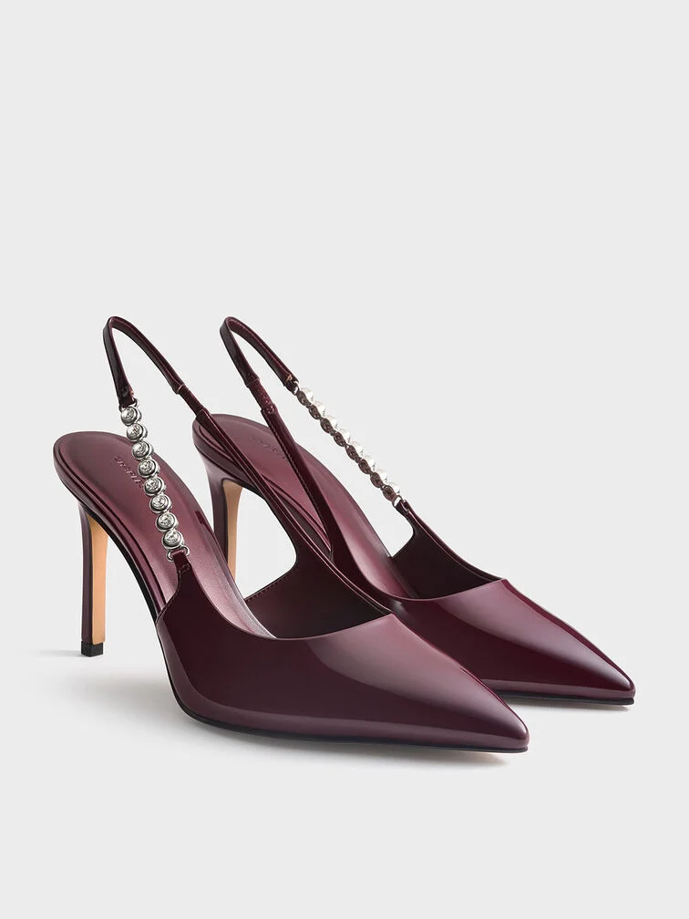 Burgundy gem-strap slingback pumps, the perfect complement to full-length evening gowns. 