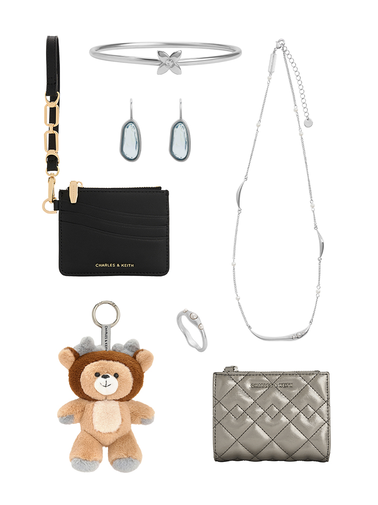 Collection of small gift items, suitable for stocking stuffers, including black card holder, silver star bracelet, turquoise crystal earrings, silver ring, brown bear keychain and quilted metallic wallet. 