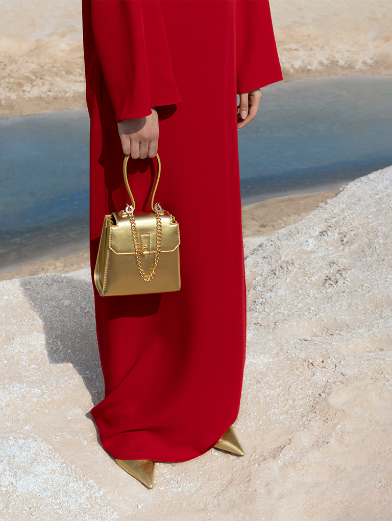 Women's Locket Chain-Link Trapeze Bag and Metallic Braided-Strap Stiletto-Heel Mules, both in gold - CHARLES & KEITH