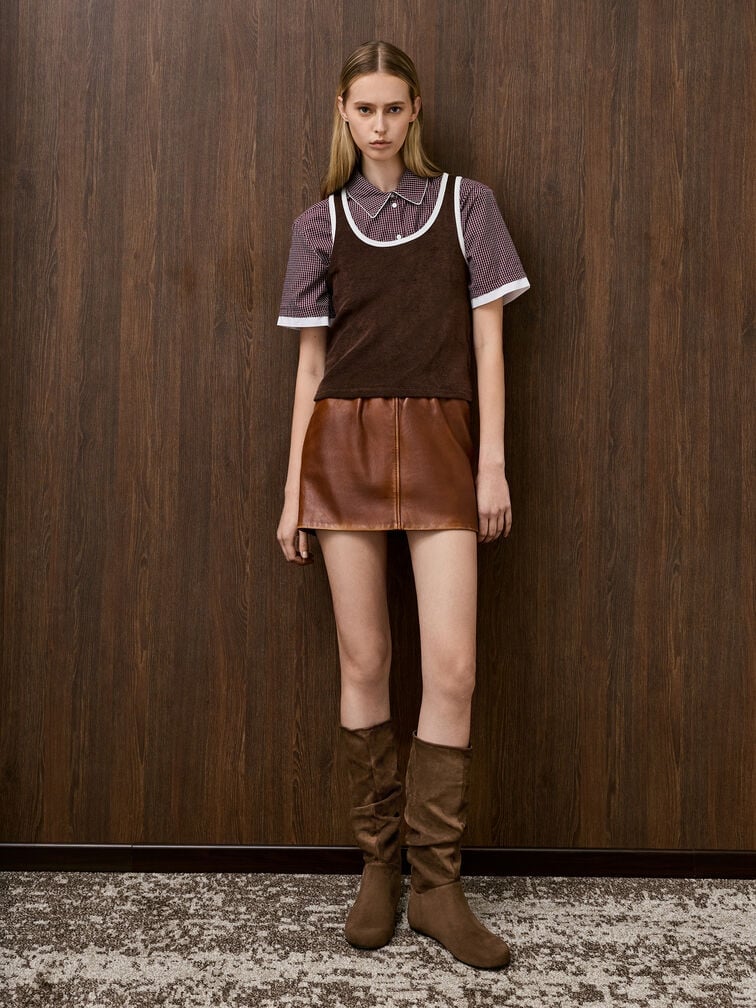 Brown ruched knee-high boots, paired with a matching layered top and mini skirt.