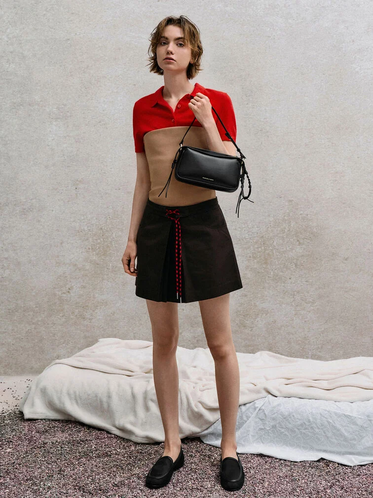 A bandeau-over-shirt styled with a mini skirt.