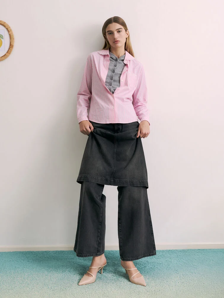 Light pink pointed-toe heeled mules paired with skirt-layered wide-leg jeans. 