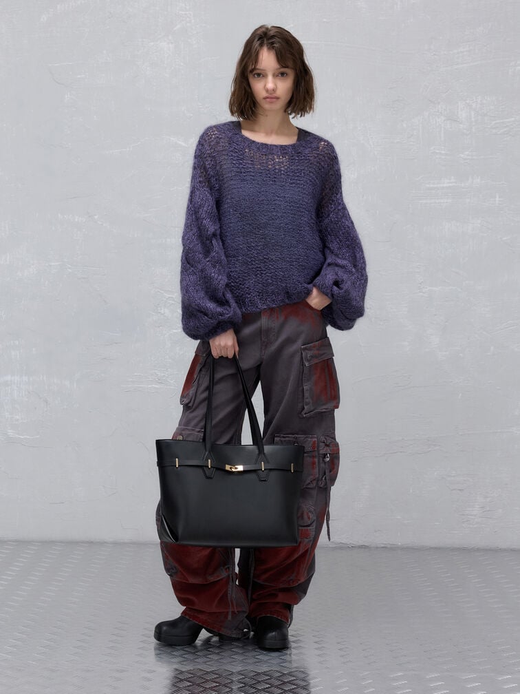 Knitted sweater paired with distressed cargo trousers and a spacious tote bag for carrying campus essentials.