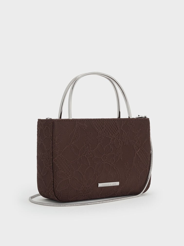  A classic dark-brown top-handle bag is a versatile and foolproof accessory choice. 