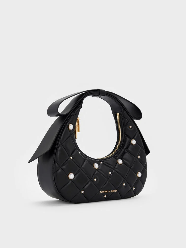 Black quilted pearl bow-handle bag, a fun yet elegant pick for black-tie events.  
