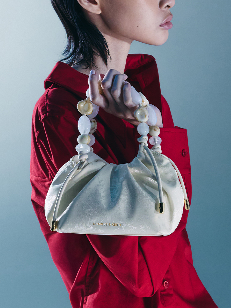 Women’s Aviary jacquard beaded-handle bag in cream - CHARLES & KEITH