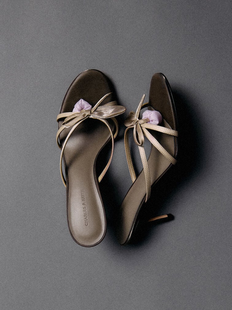 Nothing says spring quite like strappy heeled mules with flower embellishments. 